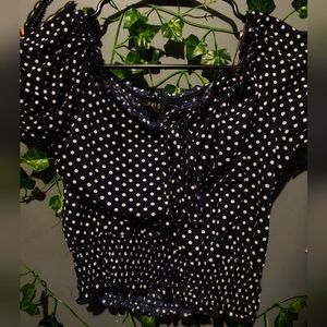 Blue cropped top with white polka dots.